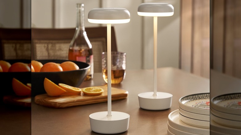 Member's Mark 2-pack of outdoor table lamps on a table with oranges and plates.