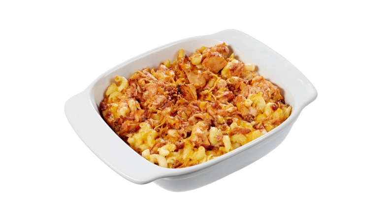 A white serving platter with BBQ chicken mac and cheese with bacon from Costco on a white background
