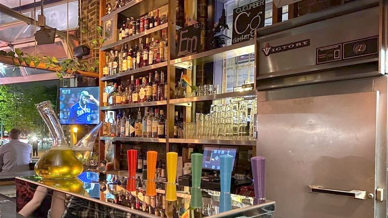 The bar at The Miracle of Science with rainbow taps and chemistry equipment