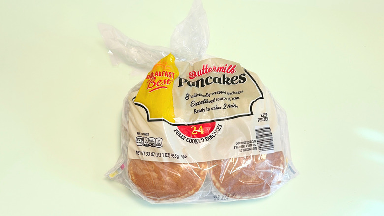 A bag of Breakfast Best Buttermilk Pancakes isolated on a light green background