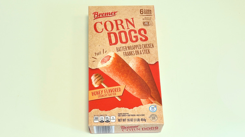 A box of Bremer Corn Dogs isolated on a light green background