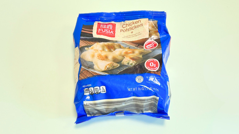 A bag of Fusia Chicken Potstickers isolated on a light green background