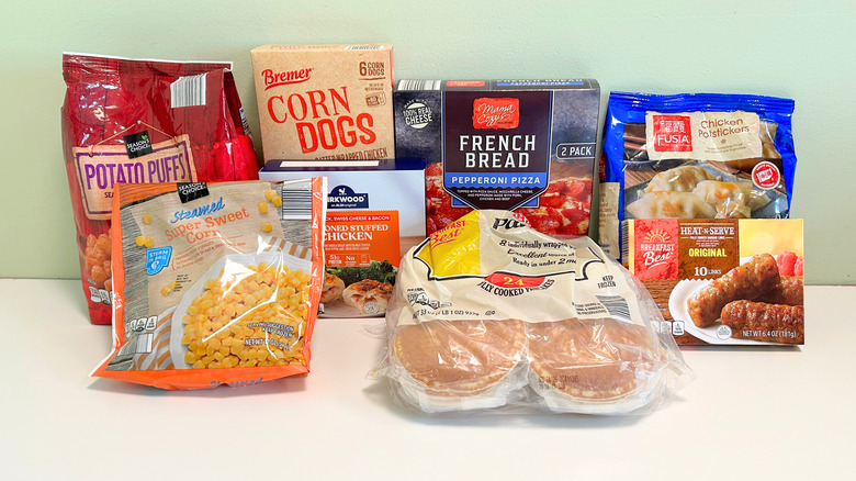 An assortment of Aldi freezer finds arranged together on a green and white background