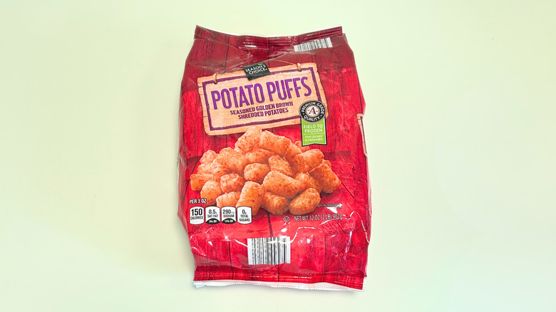 A bag of Season's Choice Potato Puffs isolated on a light green background