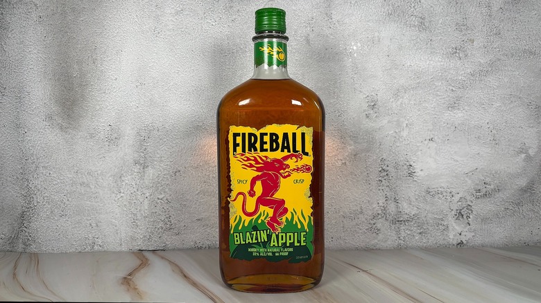 Bottle of Fireball apple whiskey on grey background