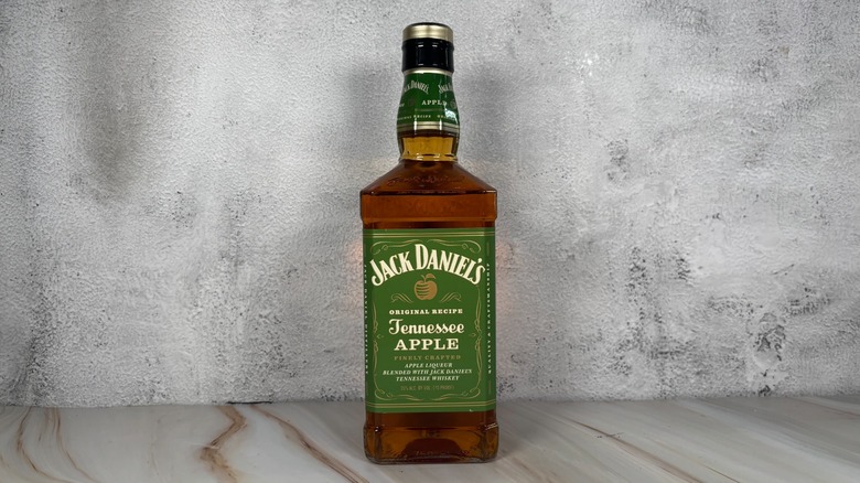 Bottle of Jack Daniel's apple whiskey on grey background