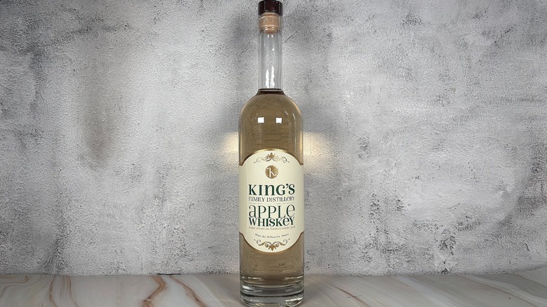 Bottle of King's Family Distillery apple whiskey on grey background