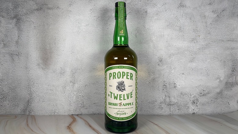 Bottle of Proper No. Twelve apple whiskey on grey background