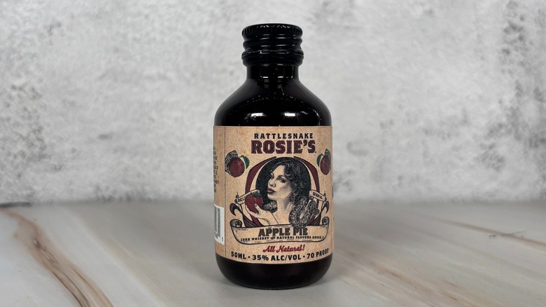 Bottle of Rattlesnake Rosie's apple whiskey on grey background