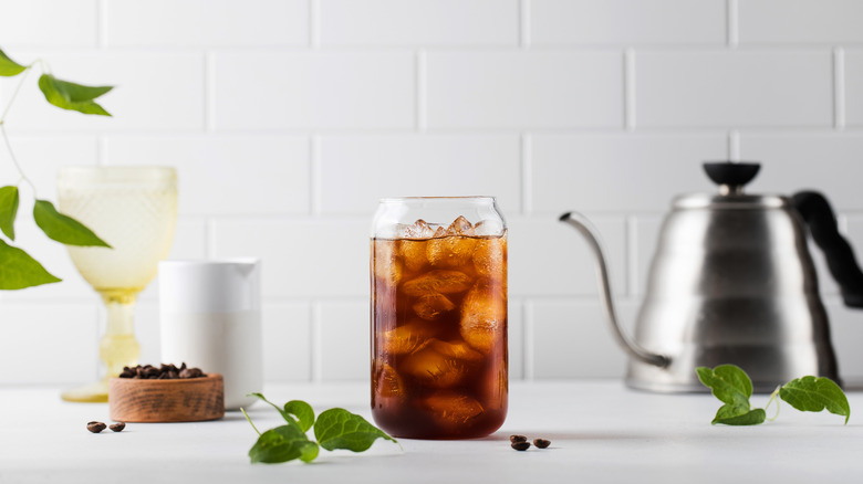 cold coffee in glass cup with beans