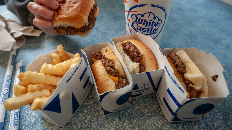 Burgers, fries, drink, and straws on White Castle table