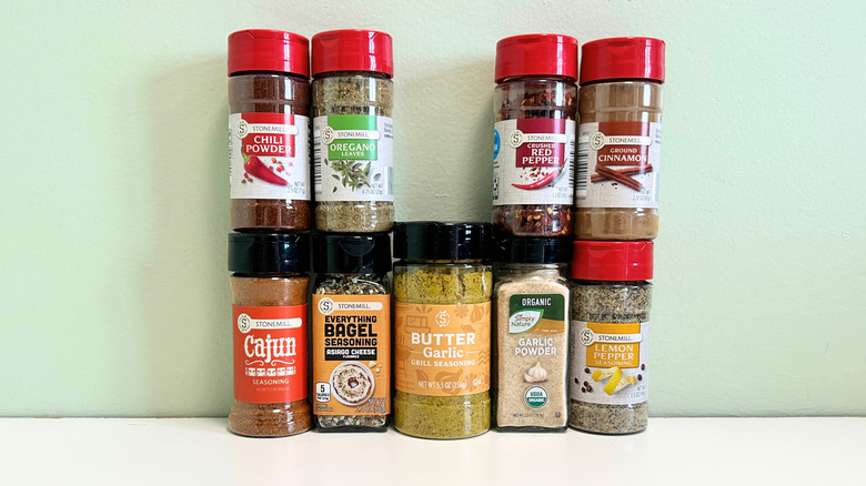 Nine Aldi spices arranged together against a green and white background