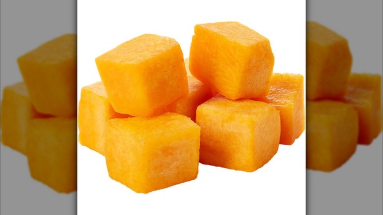 Cubed butternut squash against a white background