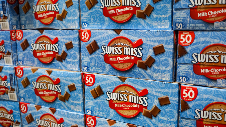 Stacked bulk cases of Swiss Miss hot chocolate mix filling the frame