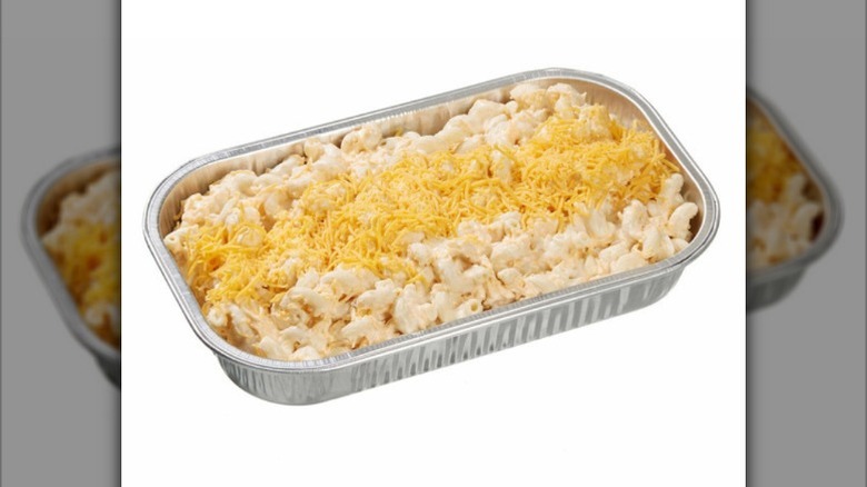 An aluminum container of Kirkland Signature macaroni and cheese against a white background