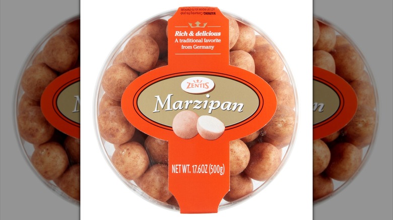 A clear plastic tub of marzipan potatoes with an orange and gold label