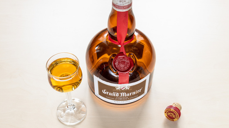 A bottle and glass of Grand Marnier liqueur