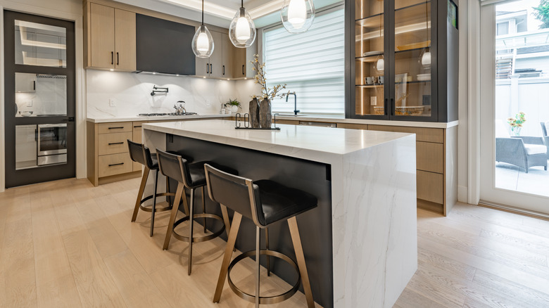 A modern kitchen with a waterfall edge island