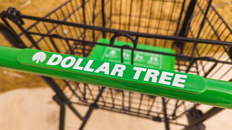 A green push bar with "DOLLAR TREE" in white text on a black shopping cart