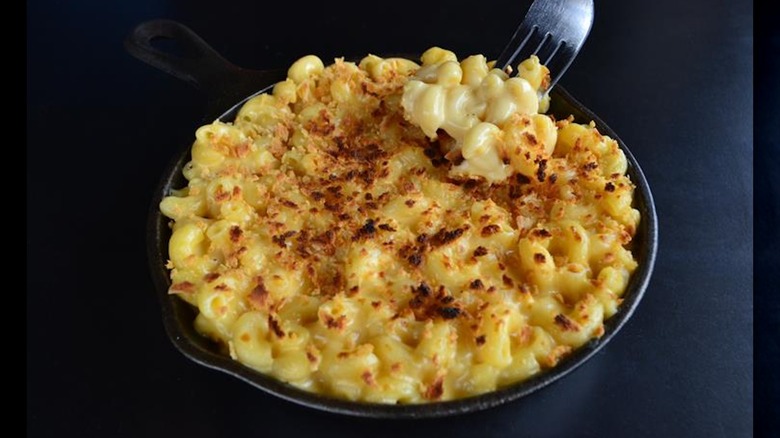 Close-up of fork scooping MacDaddy's mac and cheese from a skillet