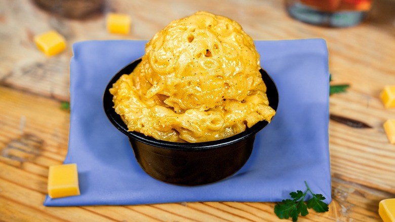 A cup of Blue Pit BBQ's mac and cheese on table top