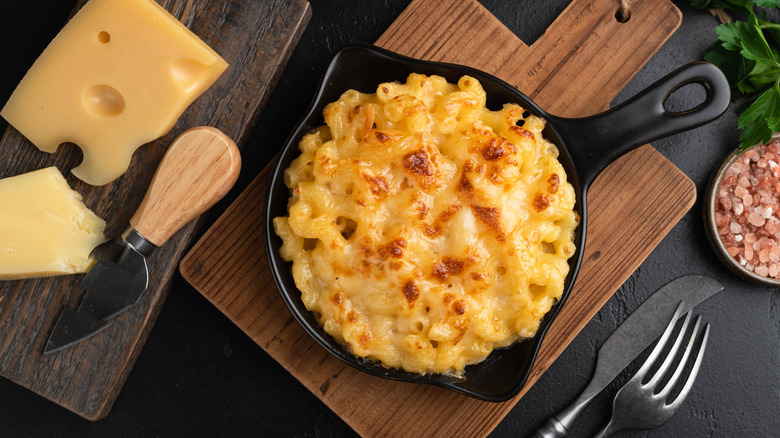 An overhead view of a skillet of mac and cheese on counter