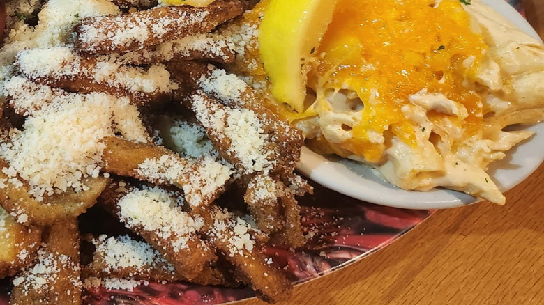 Close-up on a cup of Dempsey's mac and cheese served with seafood