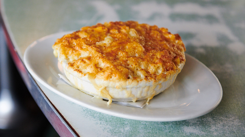 A bowl of Poole's Diner macaroni au gratin on countertop