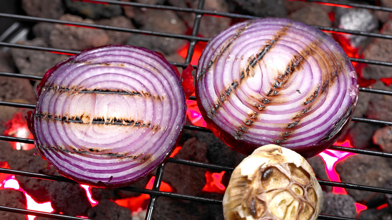 red onions and garlic on grill