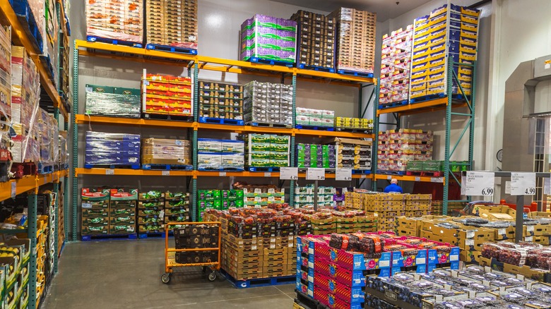 A person's hands holding a white bowl over two other stacked bowls on a table.
