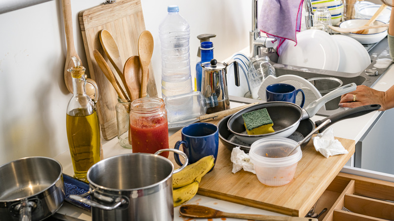 Frustrated woman surrounded by kitchen clutter