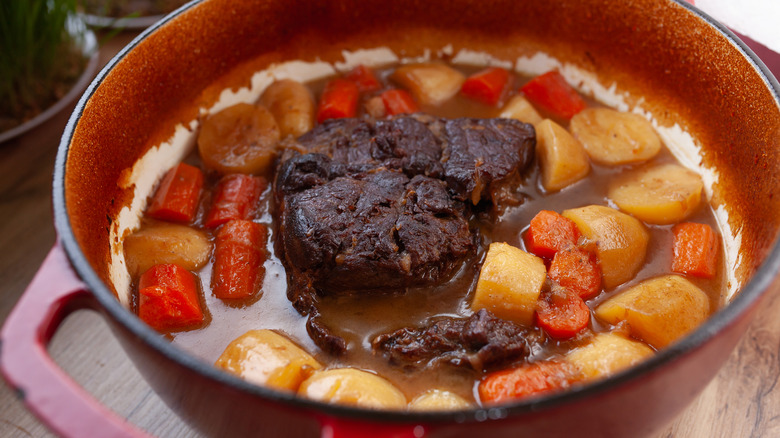 Pot roast in Dutch oven with potatoes and carrots