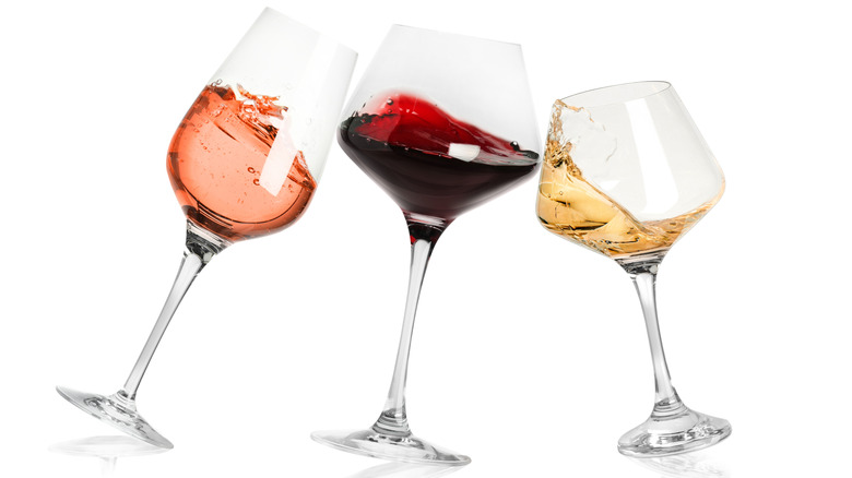 Different types of wine glasses on white background