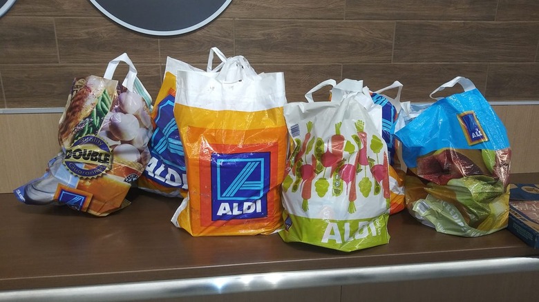 Aldi bags full of groceries on the bagging counter at the store