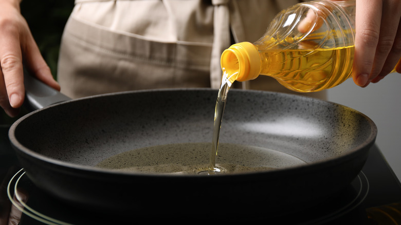 Pouring oil in a pan