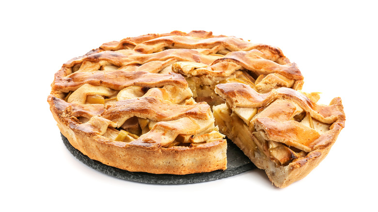 whole apple pie on a baking stone