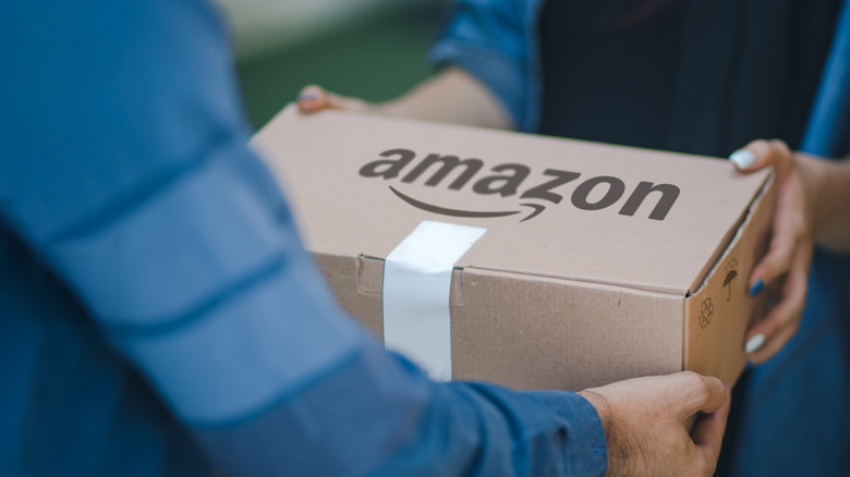 handing over an Amazon box