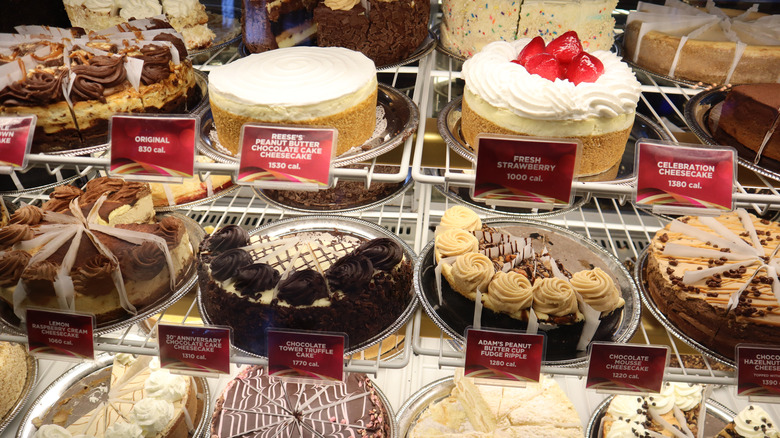 A Chessecake Factory display case featuring several cheesecakes