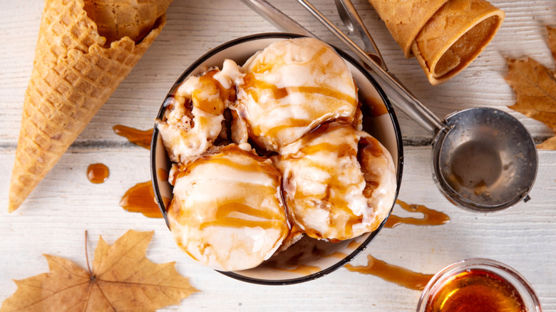 Vanilla ice cream in a bowl with maple syrup