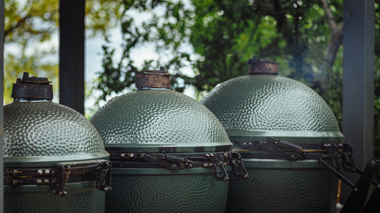 Three ceramic Kamado-style grills outdoors