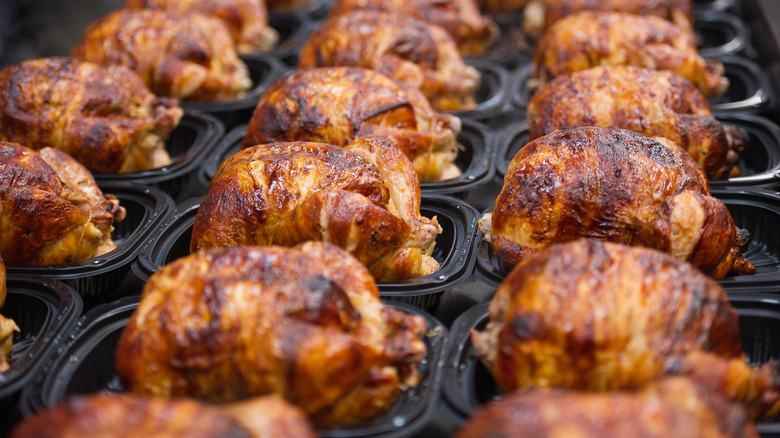 Rows of rotisserie chickens in takeout containers