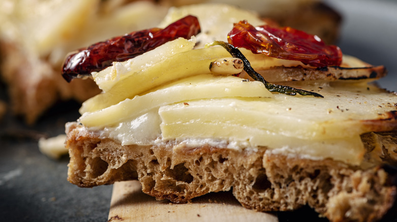 Sliced potatoes on wholegrain slice of bread