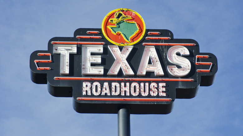 Texas Roadhouse sign in front of a blue sky