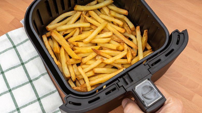 Overview of open air fryer basket with fries