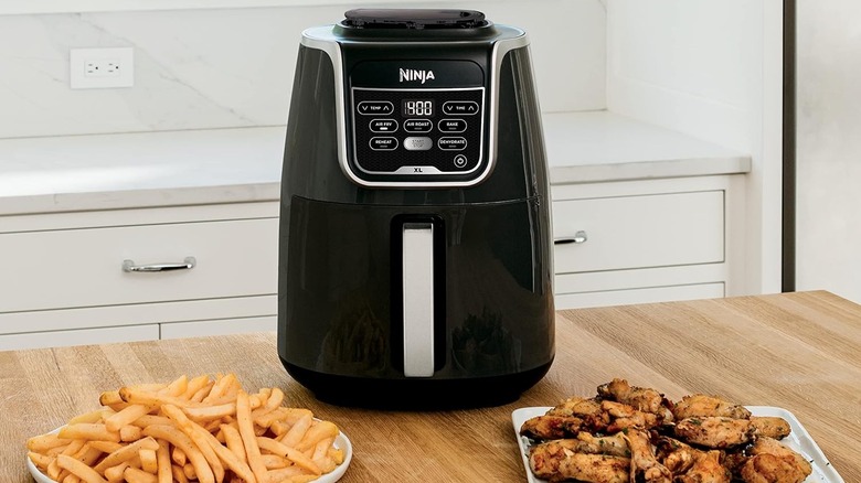 Ninja Air Fryer on counter with fries and wings