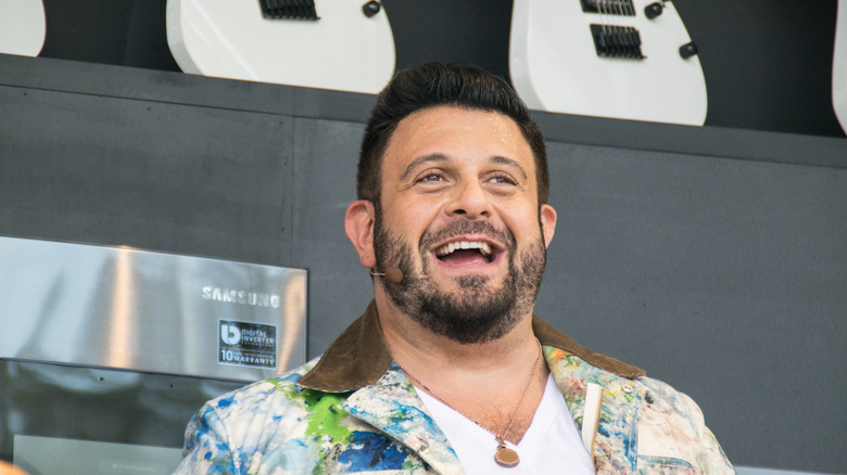 Adam Richman smiling on stage