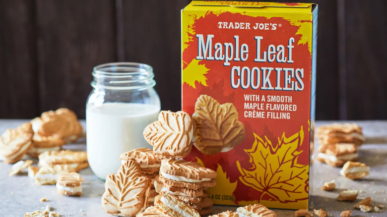 Maple leaf cookies with a glass of milk and cookie box