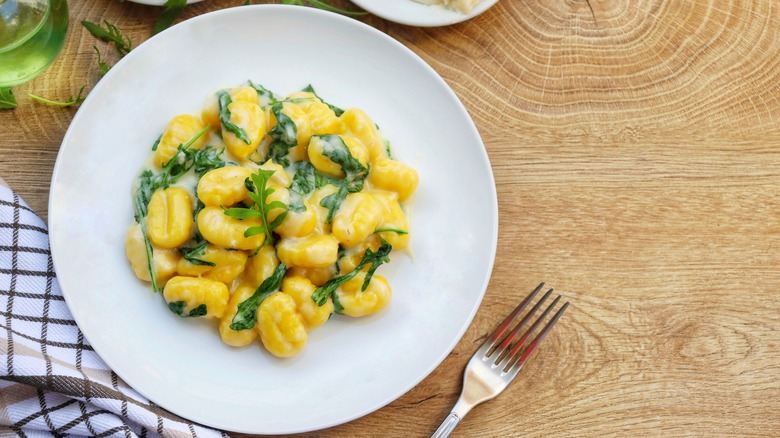 bowl of gnocchi with herbs