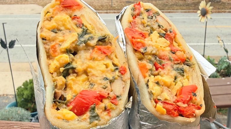 Breakfast burrito cut in half outside on patio