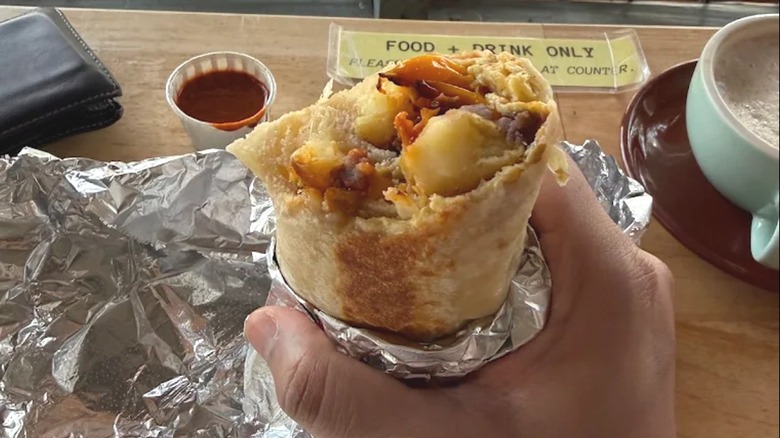 Top of breakfast burrito with bite taken out of it